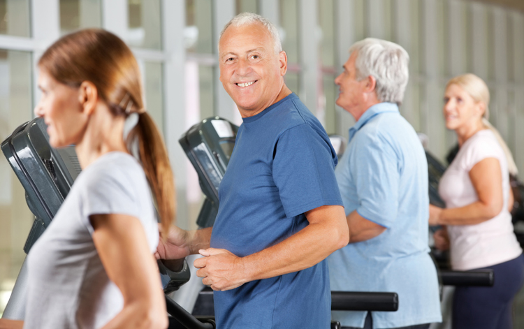 Seniors working out on treadmills.