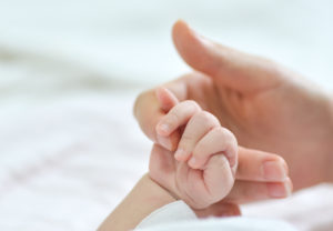 Holding Hands Mom And Newborn